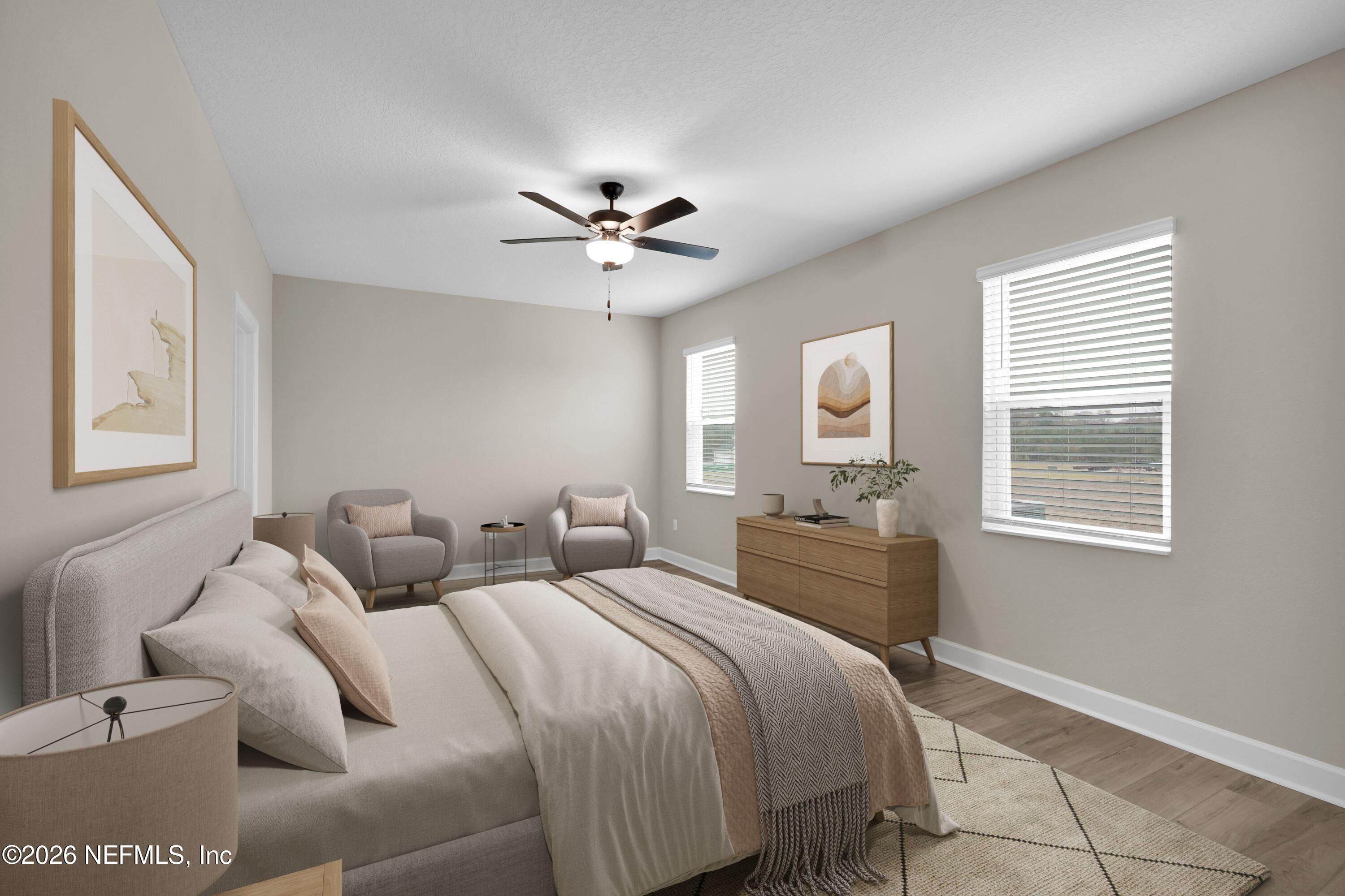 2416 Pemrose Loop Middleburg, FL 32068 - Photo 12 of 26 a bedroom with a large bed and a chandelier