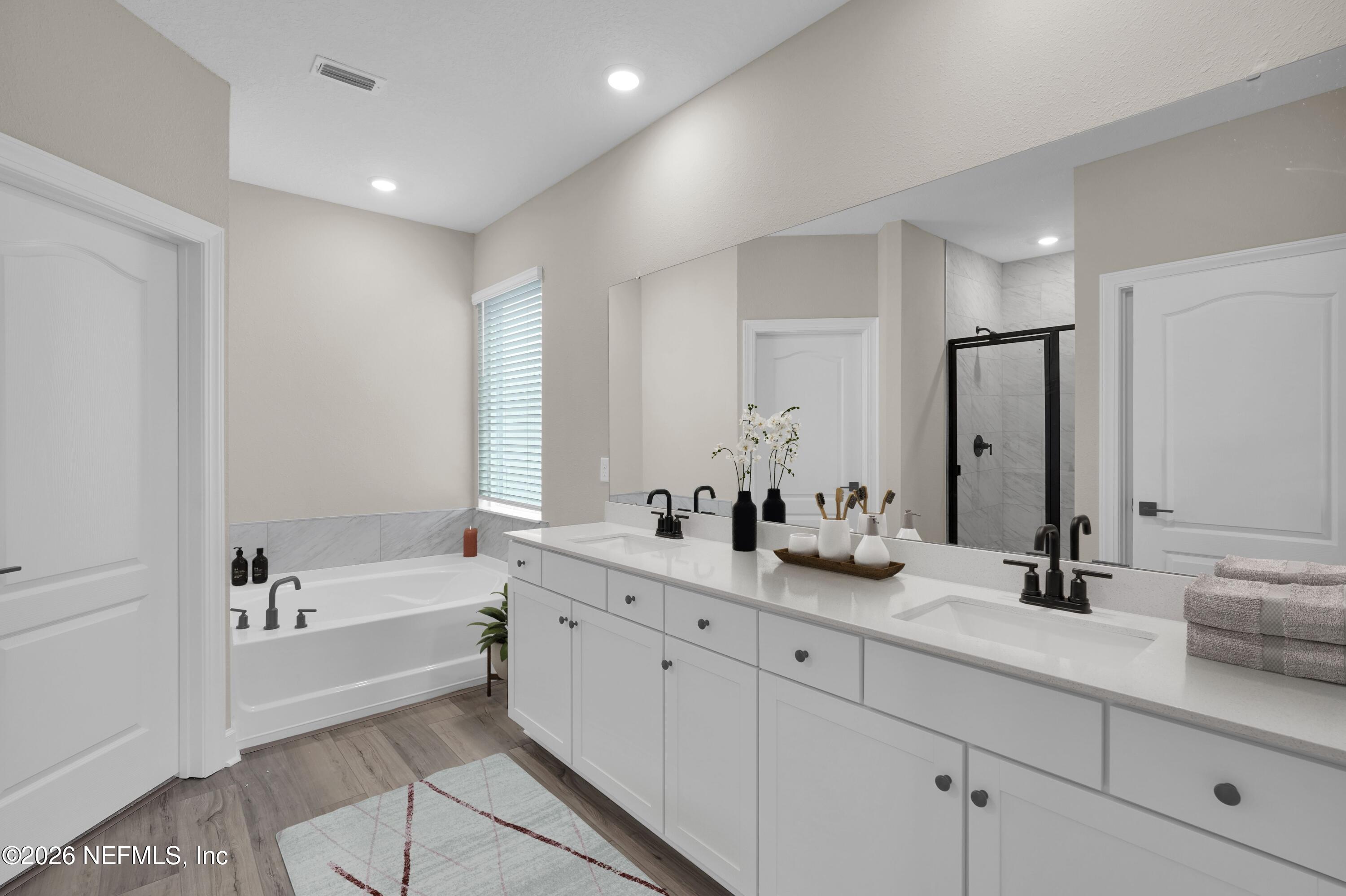 2416 Pemrose Loop Middleburg, FL 32068 - Photo 13 of 26 a bathroom with a tub sink and mirror