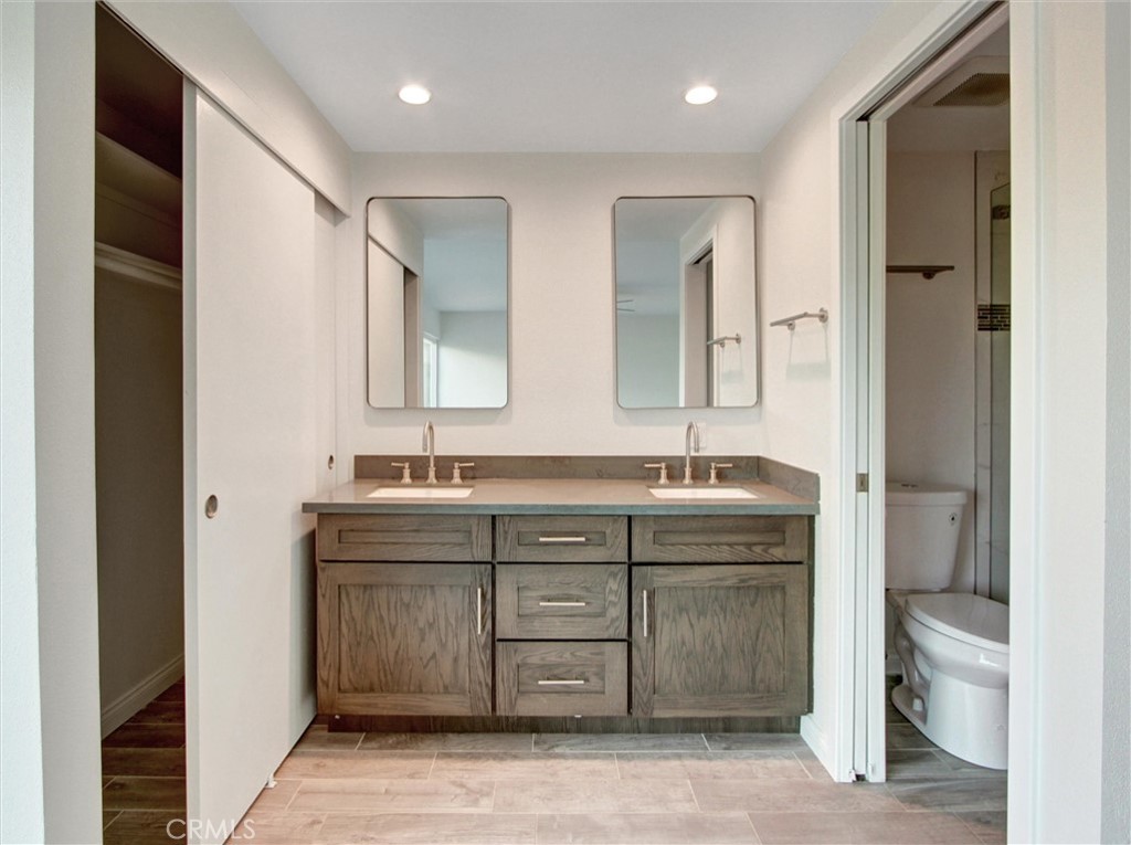 933 Carnation Avenue Costa Mesa, CA 92626 - Photo 14 of 33 a bathroom with a granite countertop sink a mirror and a