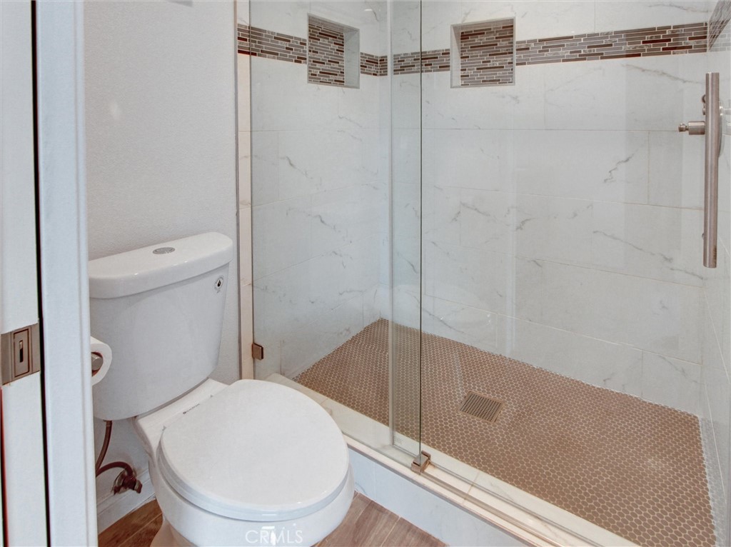 933 Carnation Avenue Costa Mesa, CA 92626 - Photo 15 of 33 a bathroom with a toilet and a shower