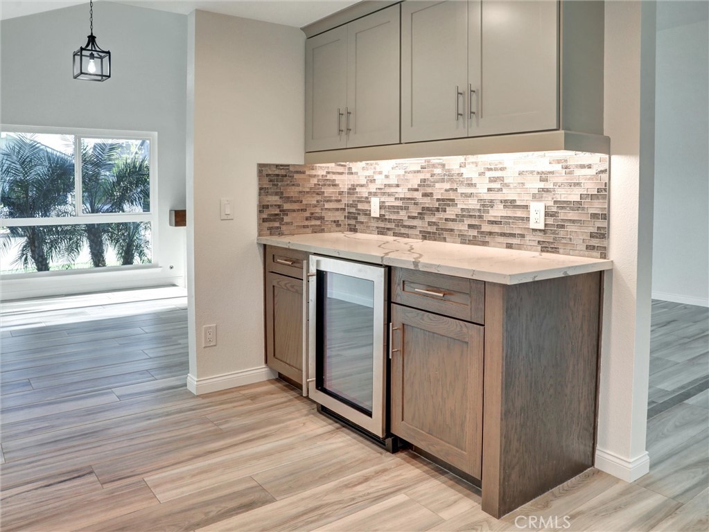 933 Carnation Avenue Costa Mesa, CA 92626 - Photo 16 of 33 a kitchen with granite countertop a sink cabinets and wooden floor
