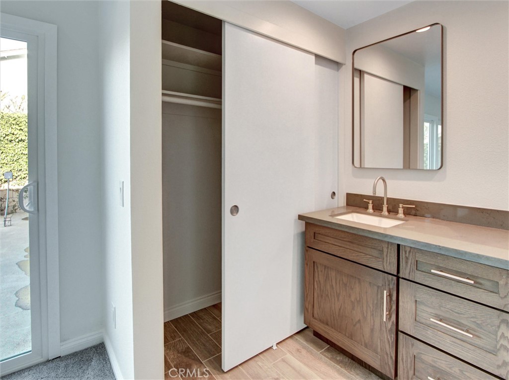 933 Carnation Avenue Costa Mesa, CA 92626 - Photo 18 of 33 a bathroom with a double vanity sink and a mirror