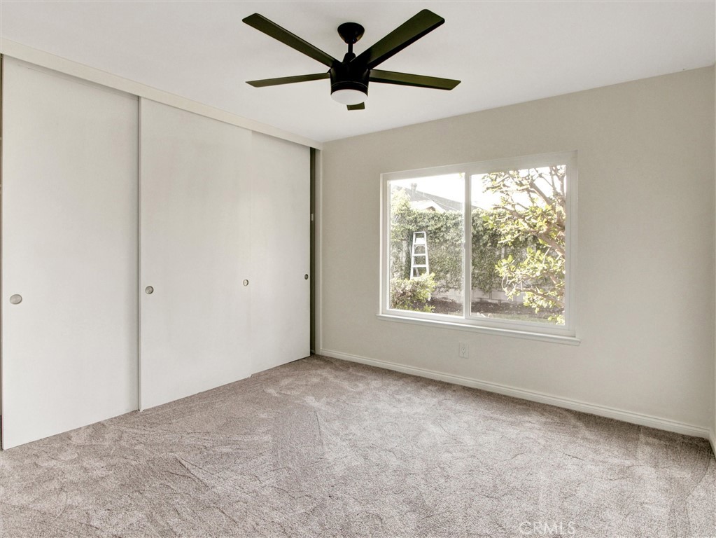933 Carnation Avenue Costa Mesa, CA 92626 - Photo 19 of 33 a view of a livingroom with a ceiling fan & window