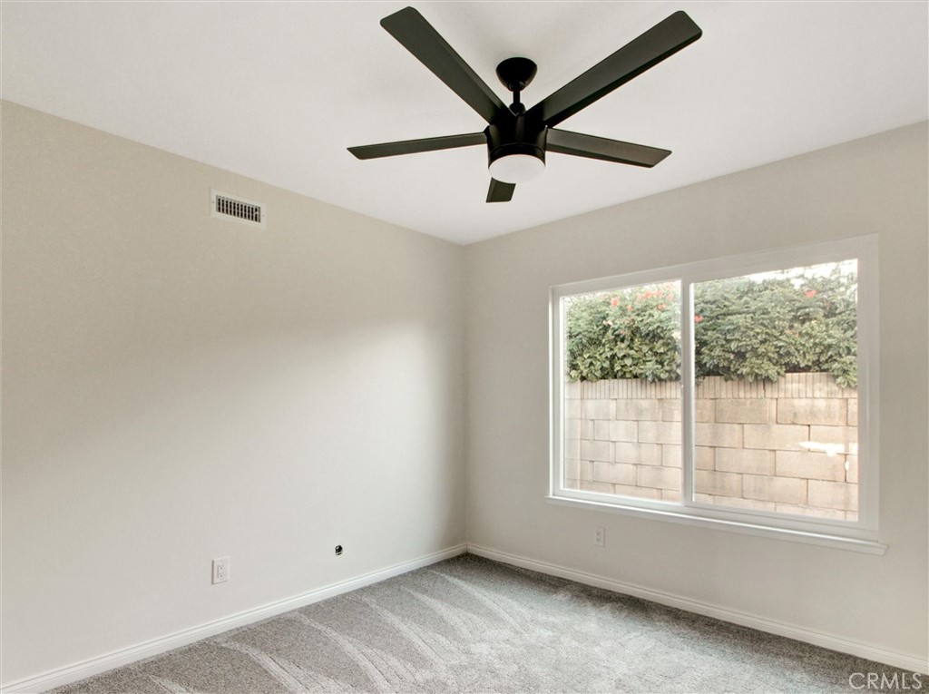 933 Carnation Avenue Costa Mesa, CA 92626 - Photo 21 of 33 an empty room with ceiling fan and windows