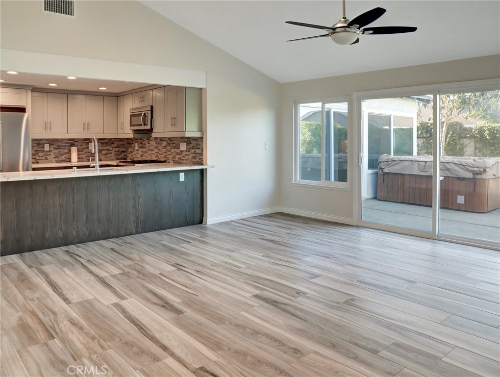 933 Carnation Avenue Costa Mesa, CA 92626 - Photo 25 of 33 a view of a kitchen with wooden floor and a window