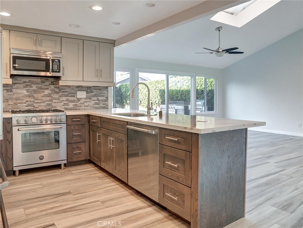933 Carnation Avenue Costa Mesa, CA 92626 - Photo 4 of 33 a kitchen with a sink stove and microwave