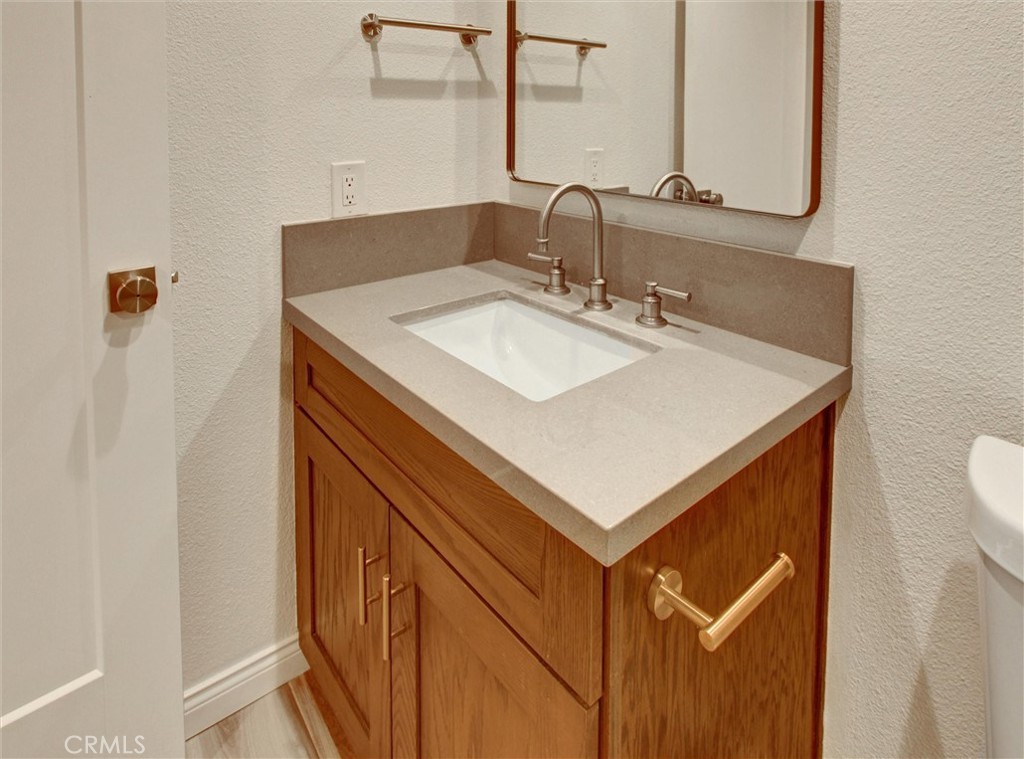 933 Carnation Avenue Costa Mesa, CA 92626 - Photo 8 of 33 a bathroom with a sink and a mirror