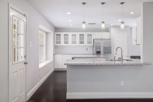 a large bathroom with a granite countertop sink a mirror and a shower
