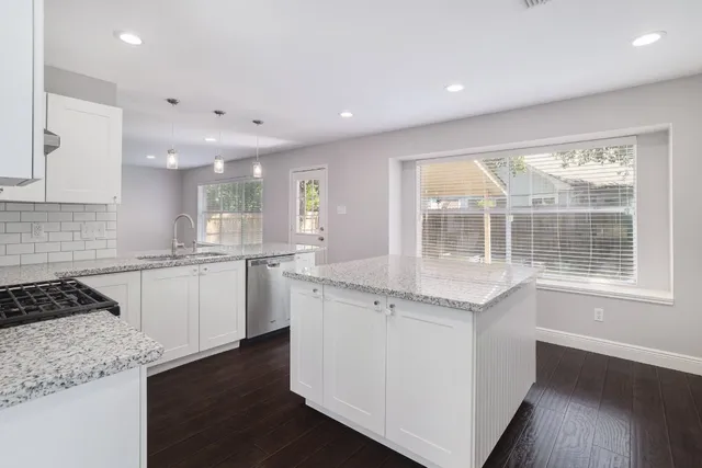 a kitchen with a sink stove and cabinets