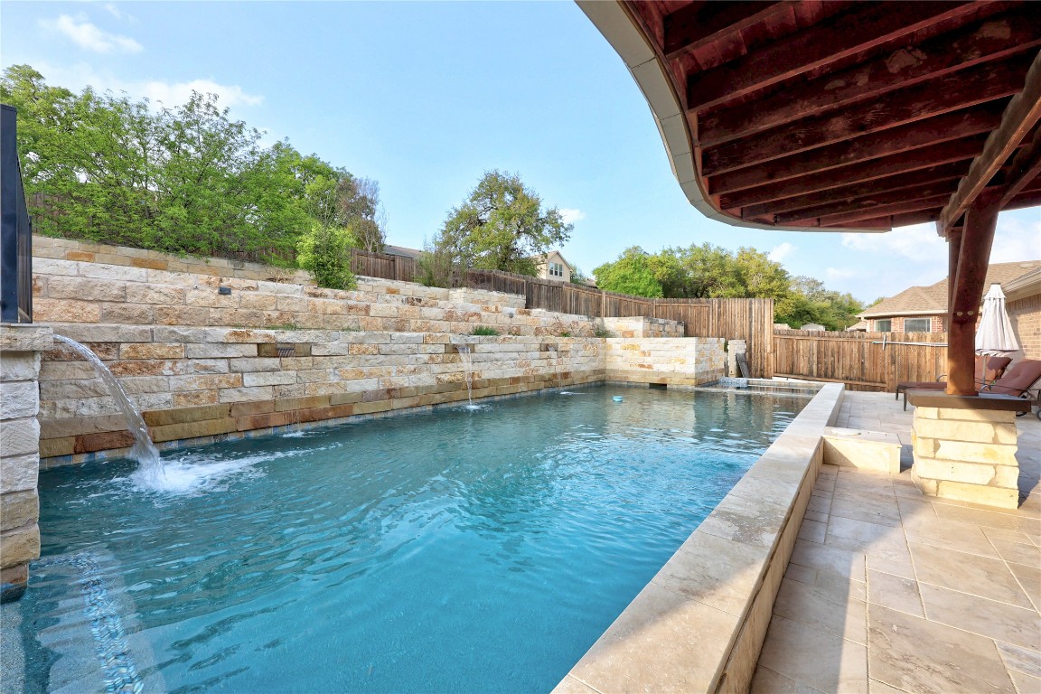 a view of swimming pool with a patio