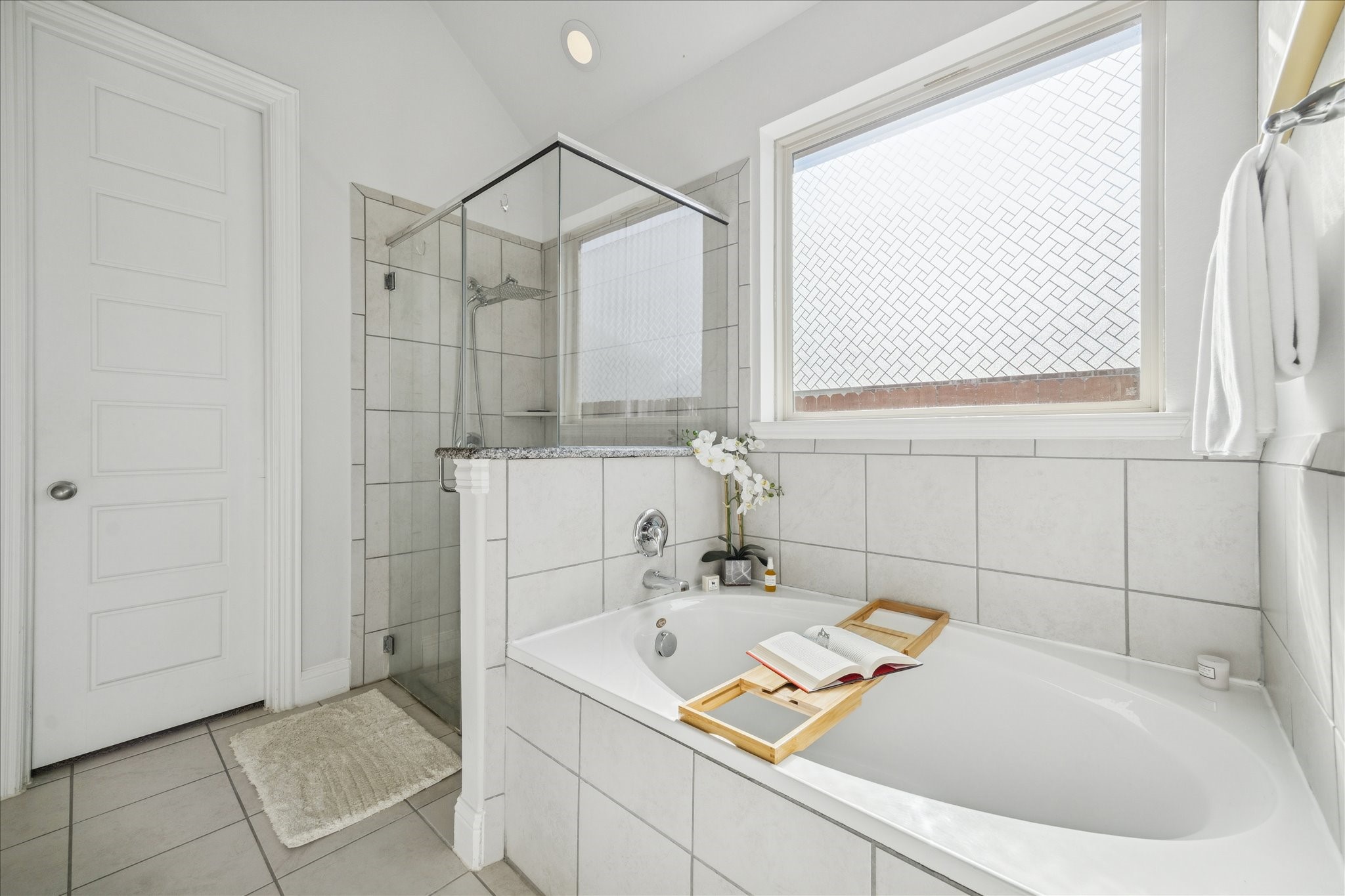 25214 Dewstone Way Porter, TX 77365 - Photo 18 of 29 Shower has frameless glass and a private window for great natural lighting. This soaker tub is the perfect spot for relaxation.