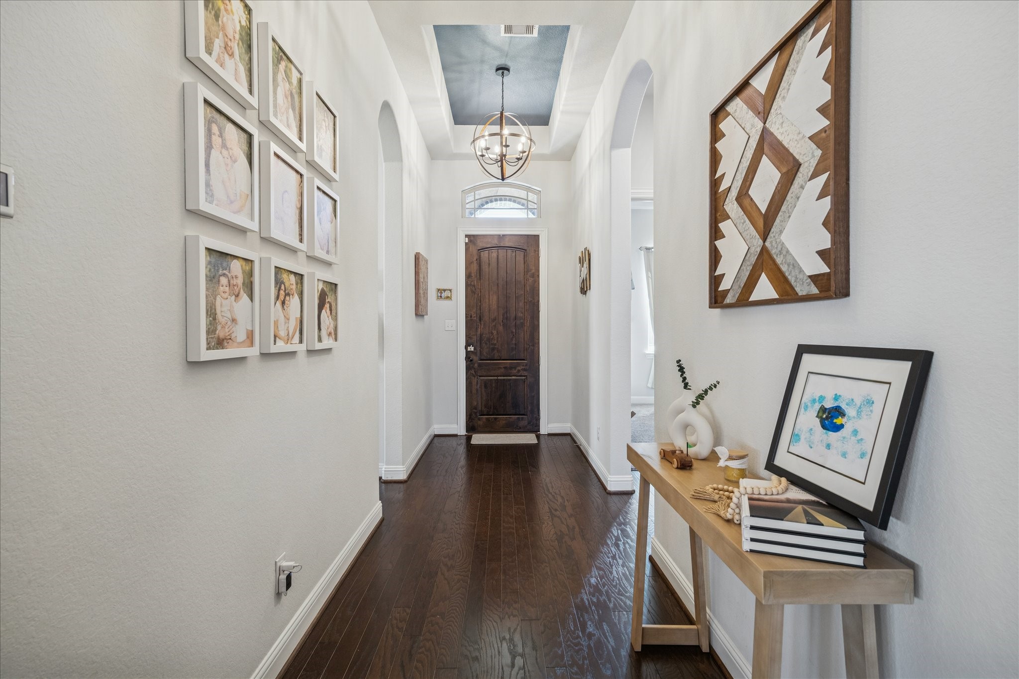 25214 Dewstone Way Porter, TX 77365 - Photo 3 of 29 This timeless architecture and decor will have you feeling at home the moment you walk in. Real engineered wood flooring, neutral paint tones and a long extended foyer give a perfect ambiance. The arched openings and detailed ceiling create a modern and elegant first impression.