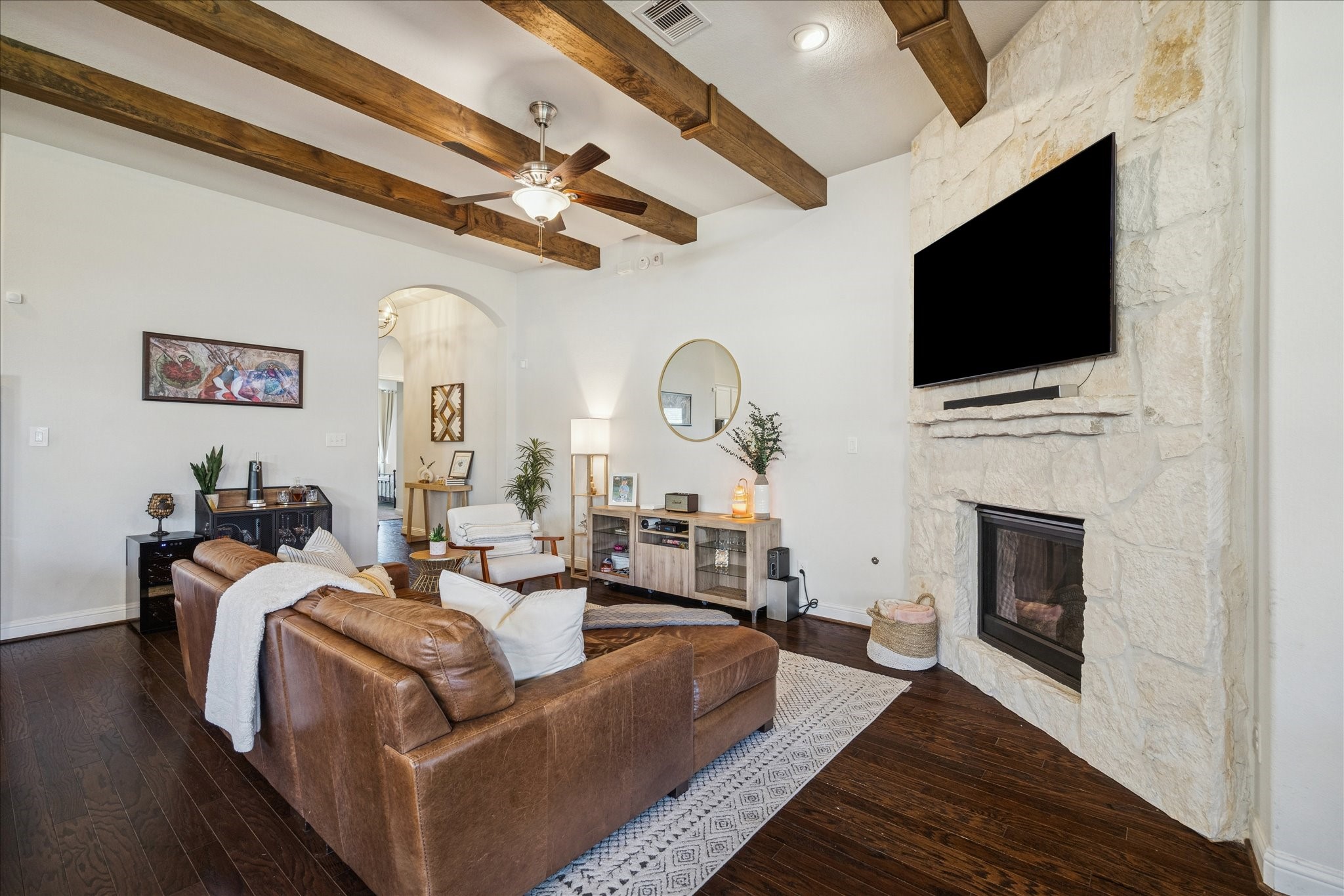 25214 Dewstone Way Porter, TX 77365 - Photo 8 of 29 Gas log fireplace is turned on with a wall switch for easy access. More arched openings to the foyer.