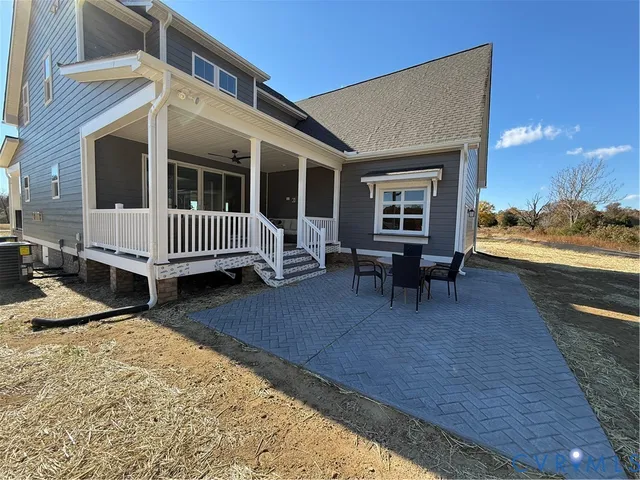 a view of a house with backyard porch and sitting area