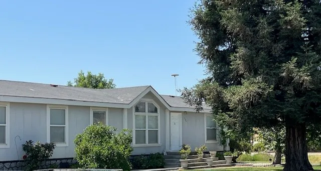 a front view of a house with trees