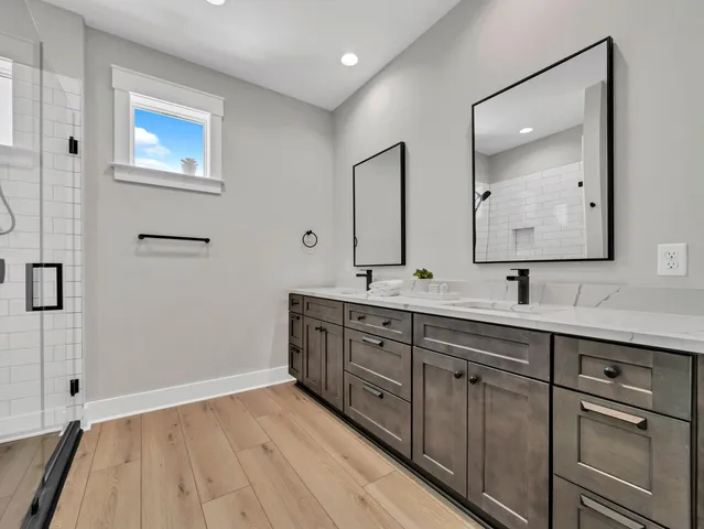 a bathroom with a double vanity sink and mirror
