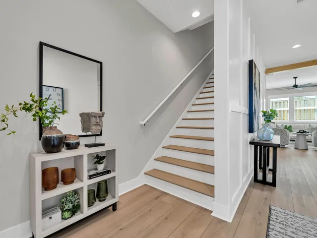 a view of a building with a big yard and large trees