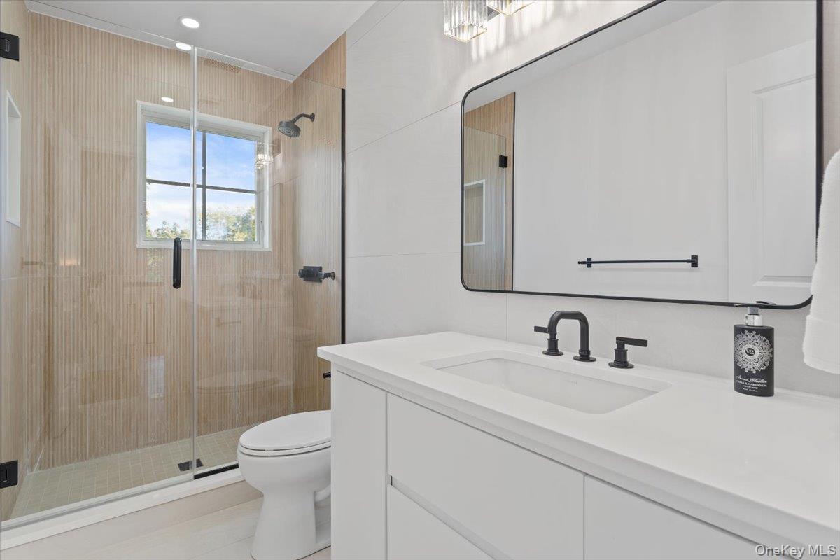 50 Franklin Avenue Rye, NY 10580 - Photo 15 of 46 a bathroom with a sink a toilet a mirror and shower