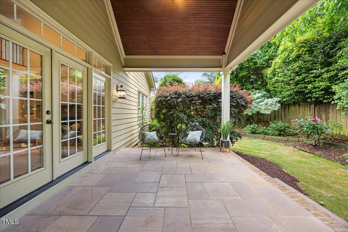 2507 Mayview Road Raleigh, NC 27607 - Photo 45 of 53 Covered stone patio with stained wood ceilings and access to living and kitchen