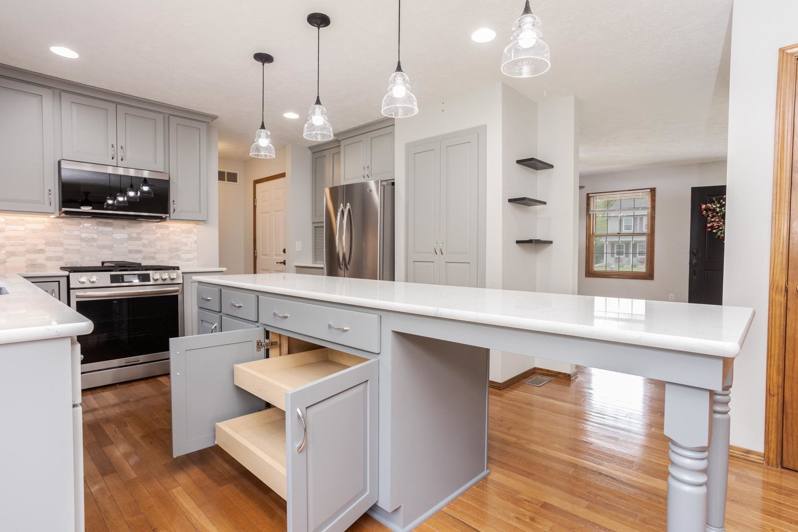 814 Landau Lane Normal, IL 61761 - Photo 20 of 58 a kitchen with stainless steel appliances granite countertop a stove a sink a oven a dining table and chairs with wooden floor