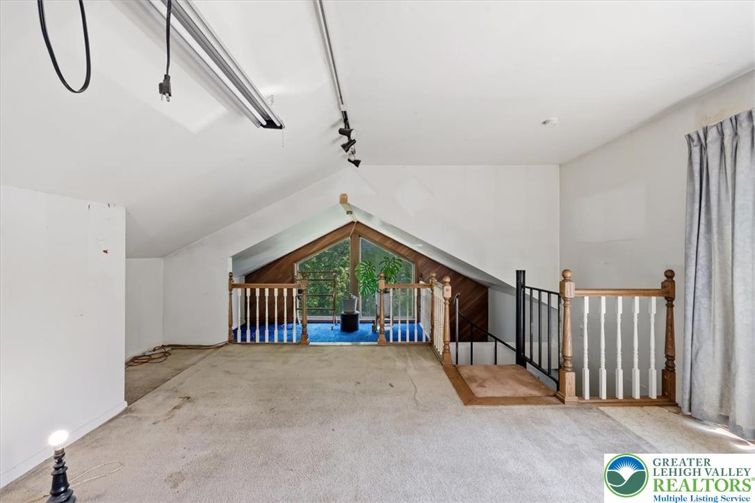 5340 2nd Street Whitehall, PA 18052 - Photo 20 of 30 A spacious attic conversion offers versatile space with a bright, peaked window overlooking nature.