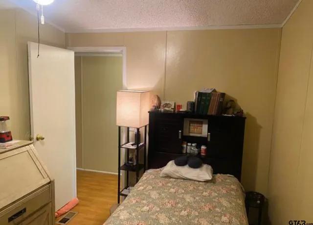 a bedroom with a bed and a desk