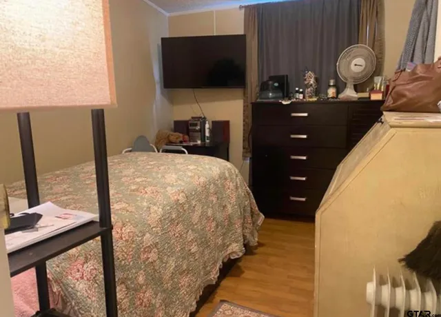 a bedroom with a bed and flat screen tv