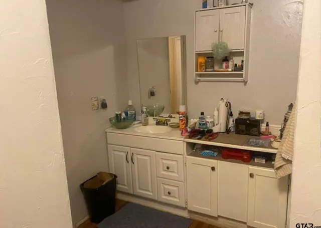 a bathroom with a sink and a mirror