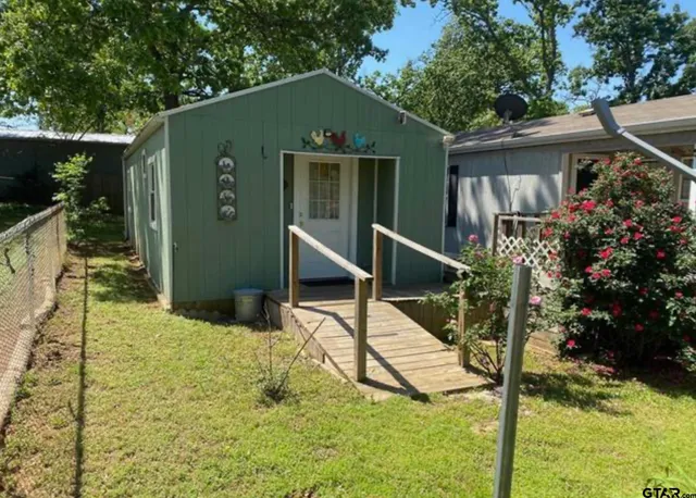 a view of a house with backyard and sitting area