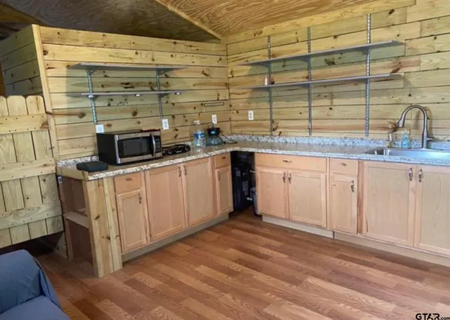 a kitchen with stainless steel appliances granite countertop a sink and cabinets