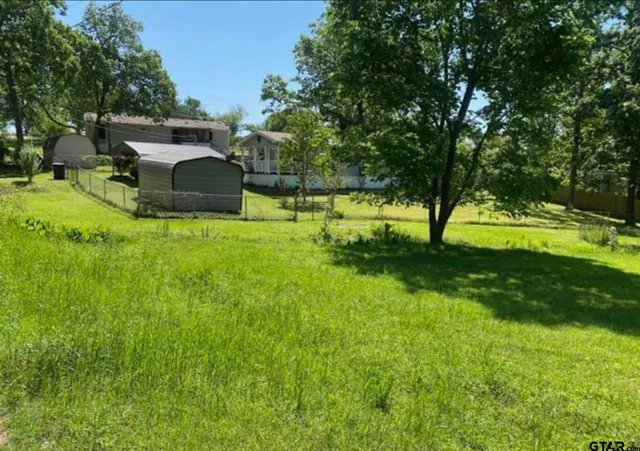 a view of a backyard with swimming pool