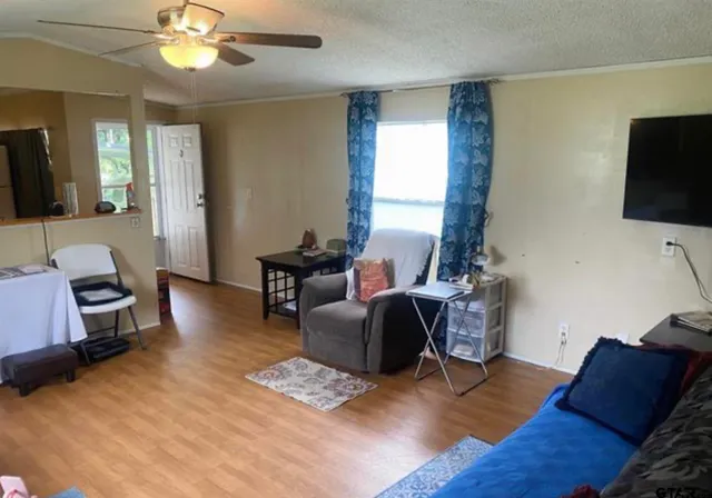 a living room with furniture and a flat screen tv