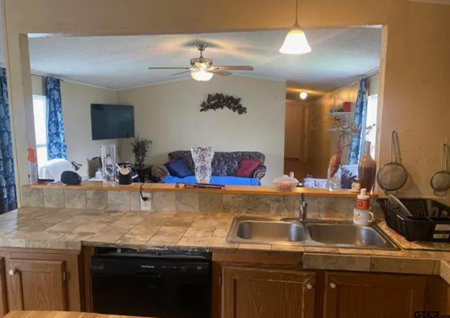 a view of a kitchen with a sink and chandelier