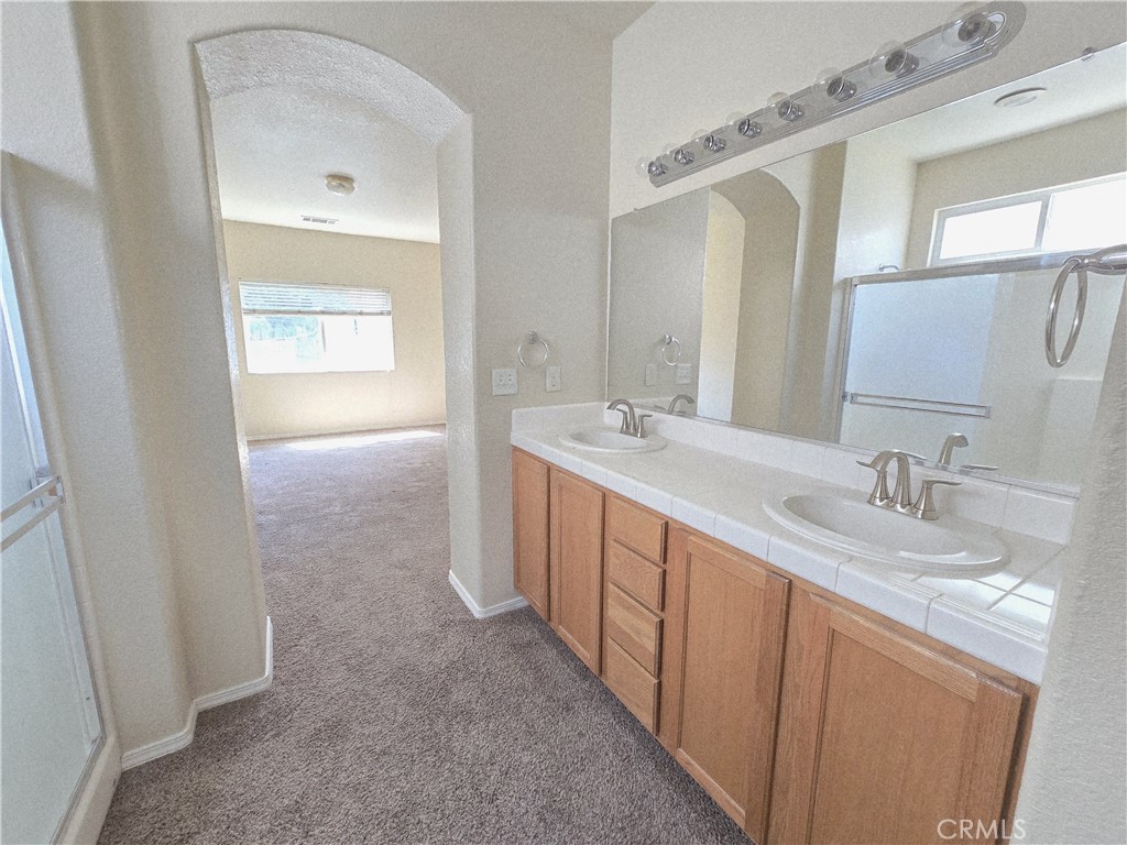 2656 Mira Court Merced, CA 95341 - Photo 17 of 23 a bathroom with double sink and a mirror