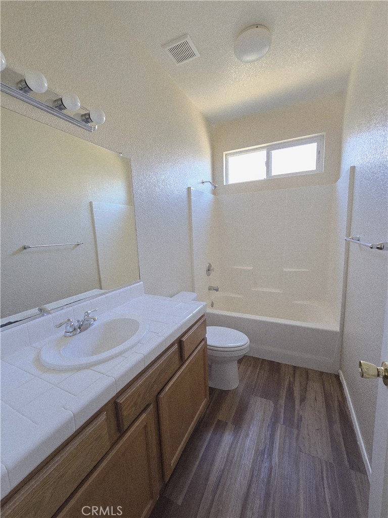 2656 Mira Court Merced, CA 95341 - Photo 19 of 23 a bathroom with a granite countertop sink toilet a large mirror and shower