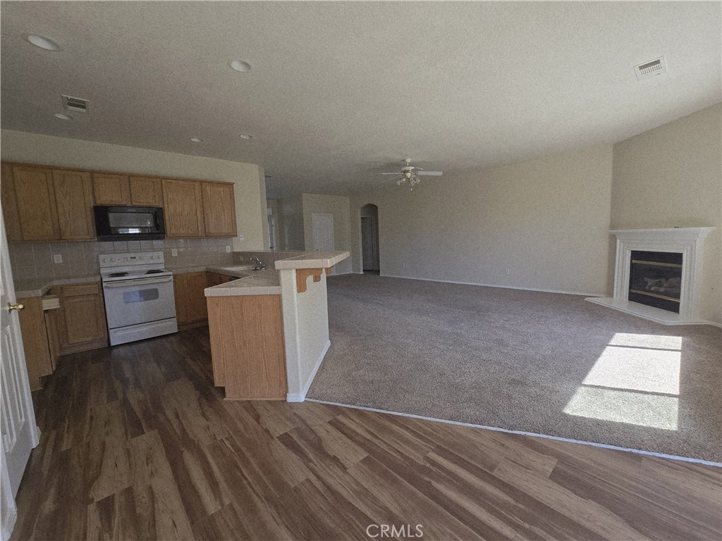 2656 Mira Court Merced, CA 95341 - Photo 4 of 23 a view of a kitchen with microwave and cabinets