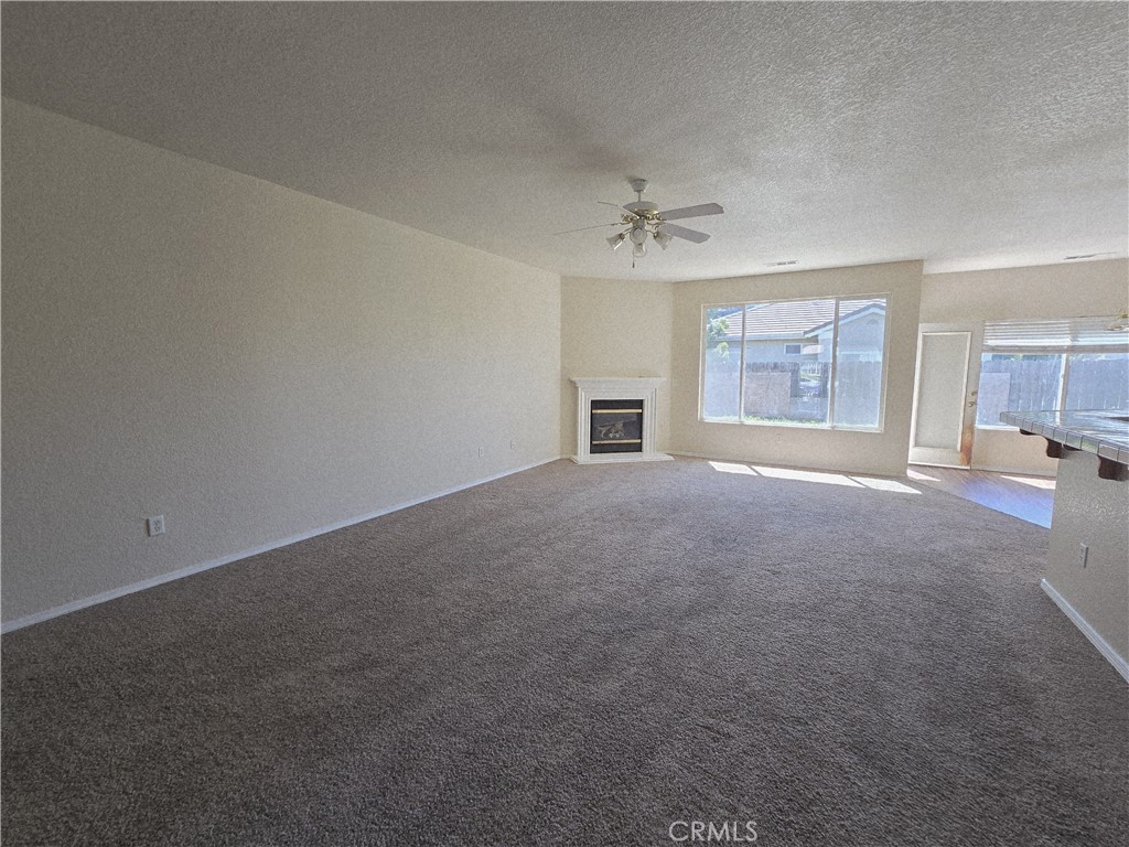 2656 Mira Court Merced, CA 95341 - Photo 8 of 23 an empty room with windows and fireplace