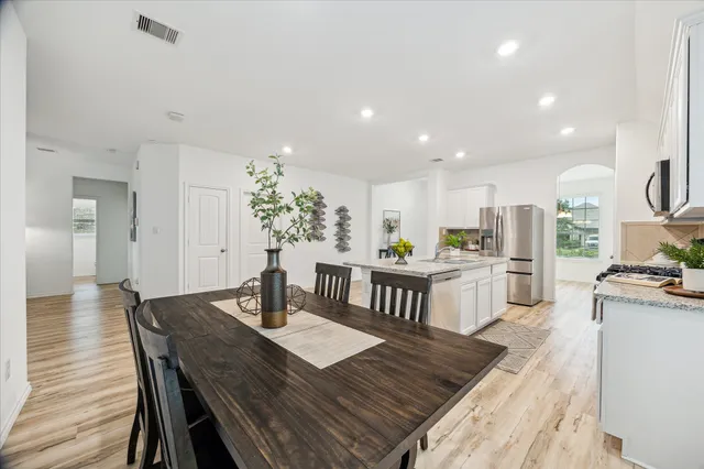 a kitchen with a table and chairs in it