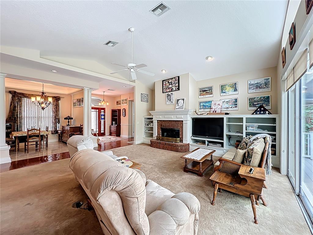 214 Chestnut Ridge Street Winter Springs, FL 32708 - Photo 16 of 68 a living room with furniture and a fireplace