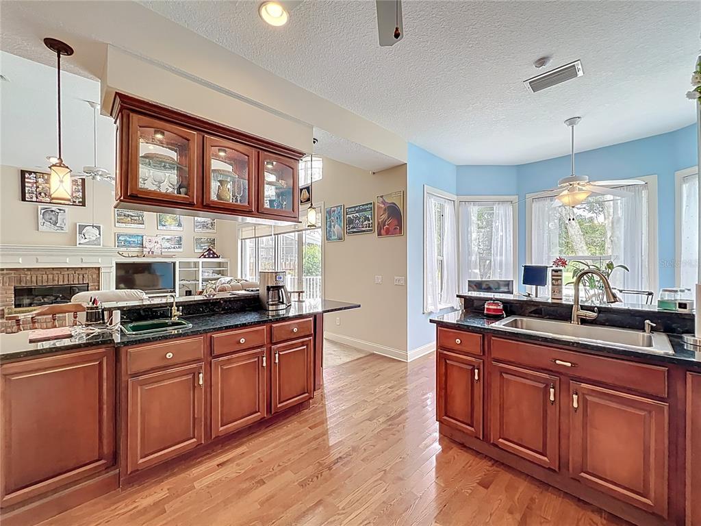 214 Chestnut Ridge Street Winter Springs, FL 32708 - Photo 20 of 68 a kitchen with stainless steel appliances wooden cabinets and a stove top oven
