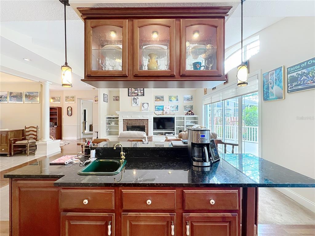 214 Chestnut Ridge Street Winter Springs, FL 32708 - Photo 26 of 68 a kitchen with stainless steel appliances granite countertop a sink a stove and cabinets