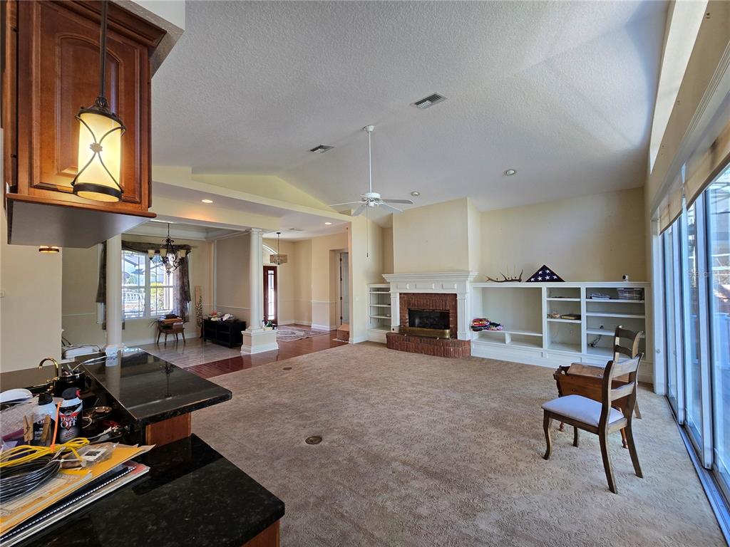 214 Chestnut Ridge Street Winter Springs, FL 32708 - Photo 31 of 68 a living room with furniture a fireplace and a flat screen tv