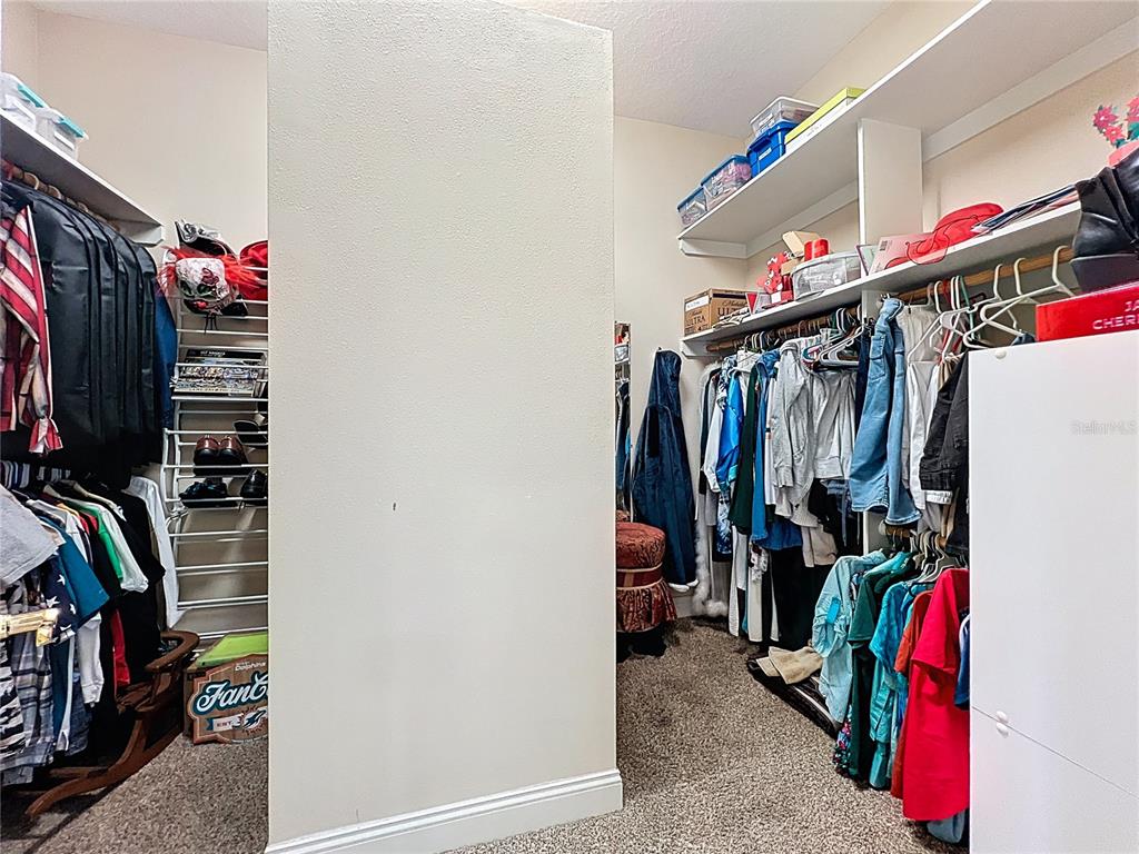 214 Chestnut Ridge Street Winter Springs, FL 32708 - Photo 36 of 68 a view of walk in closet with clothes and shoes