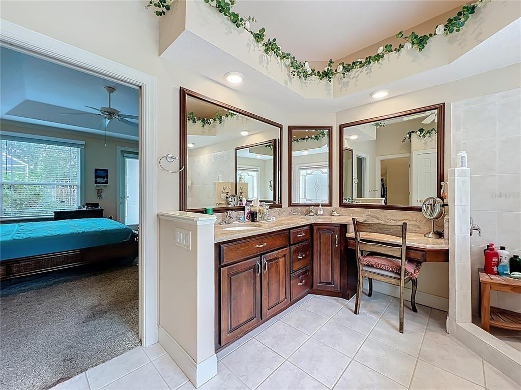 214 Chestnut Ridge Street Winter Springs, FL 32708 - Photo 37 of 68 a spacious en suite bathroom with a double vanity sink and a large mirror