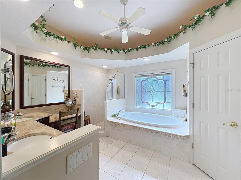 214 Chestnut Ridge Street Winter Springs, FL 32708 - Photo 38 of 68 a bathroom with a sink and a mirror with bathtub