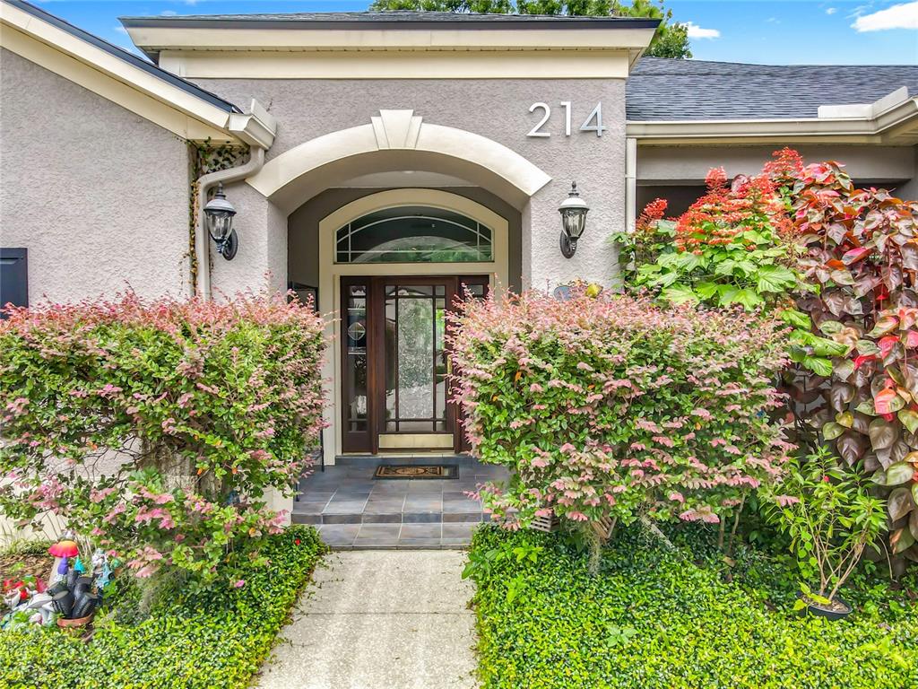 214 Chestnut Ridge Street Winter Springs, FL 32708 - Photo 4 of 68 a front view of a house with plants