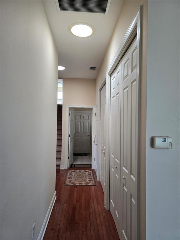 214 Chestnut Ridge Street Winter Springs, FL 32708 - Photo 51 of 68 a view of a hallway with wooden floor and a bathroom