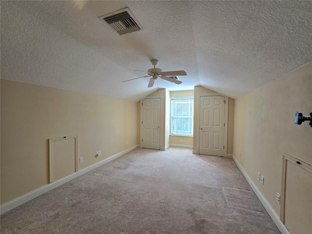 214 Chestnut Ridge Street Winter Springs, FL 32708 - Photo 52 of 68 an empty room with a ceiling fan and a window