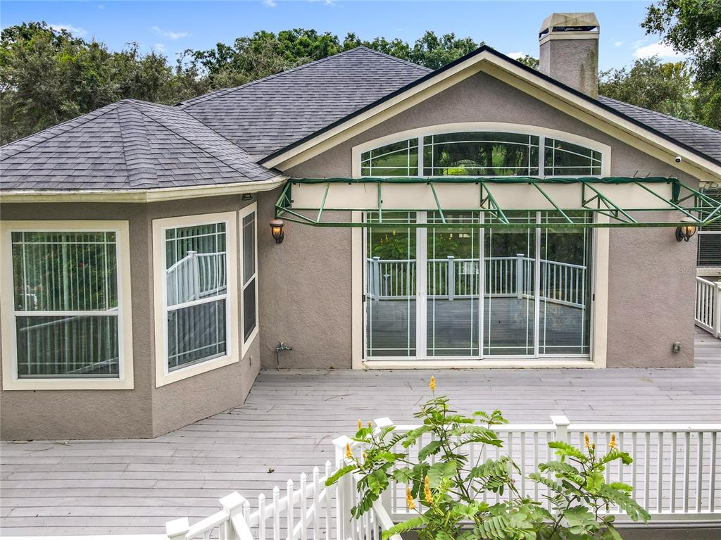 214 Chestnut Ridge Street Winter Springs, FL 32708 - Photo 62 of 68 a front view of a house with a large window and potted plants