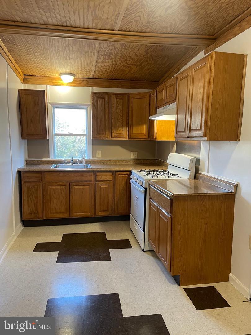 67 Sunshine Road Upper Darby, PA 19082 - Photo 7 of 21 a kitchen with stainless steel appliances granite countertop a sink stove and refrigerator